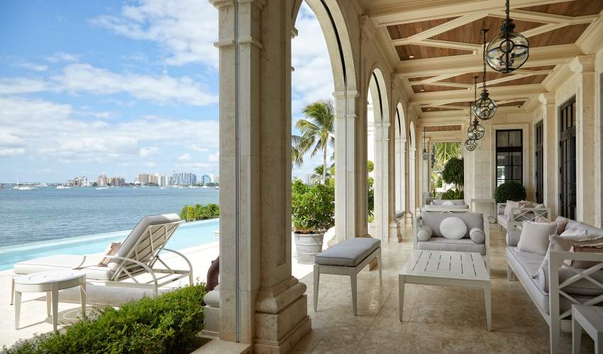 McKinnon and Harris Pavilion Collection and Otey Sun Chaise and under a loggia at a home in Florida. Design by Heather Wells.