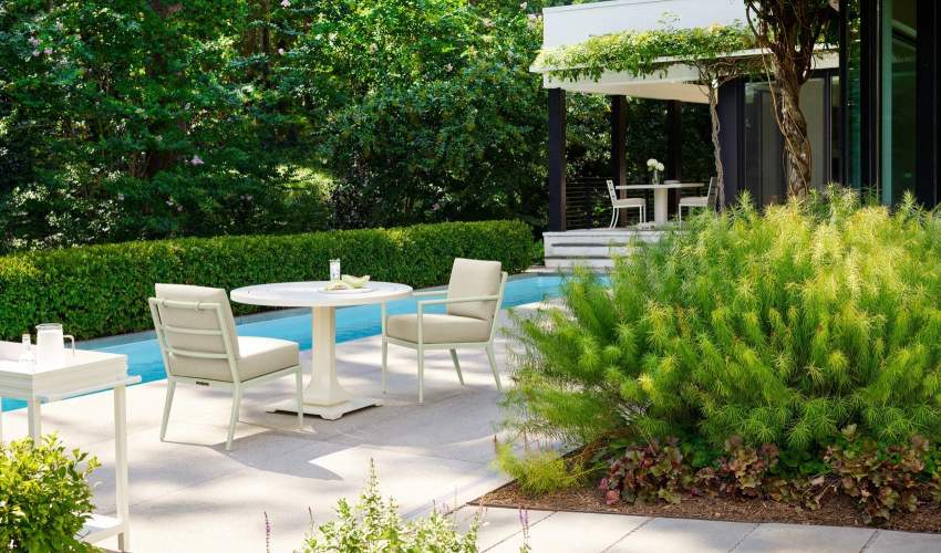 deCamp Dining Side Chair and deCamp Dining Arm Chair pulled up to a Mundy Round Dining Table at a home in Charlottesville, Va