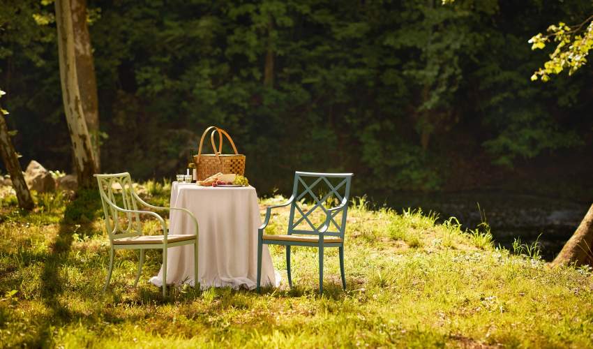 McKinnon and Harris 35th Anniversary Buie and Otey dining arm chairs with high performance rush seats at an outdoor garden table