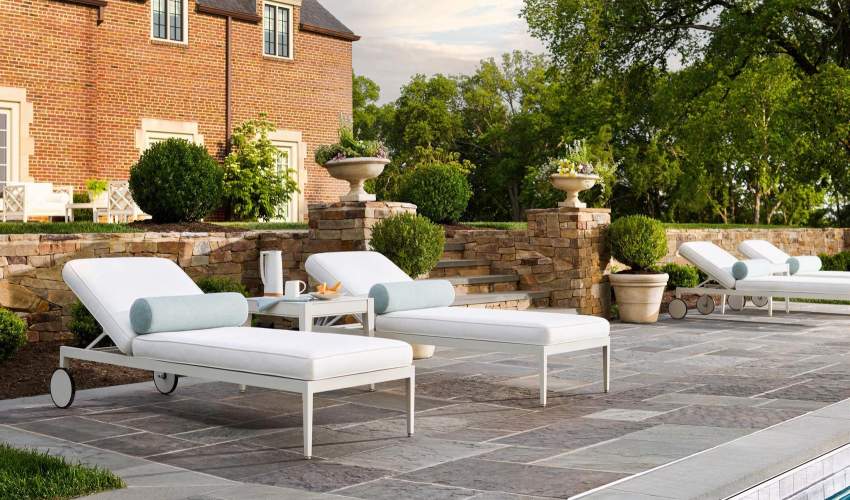 Rives Sunchaise poolside on a stone terrace